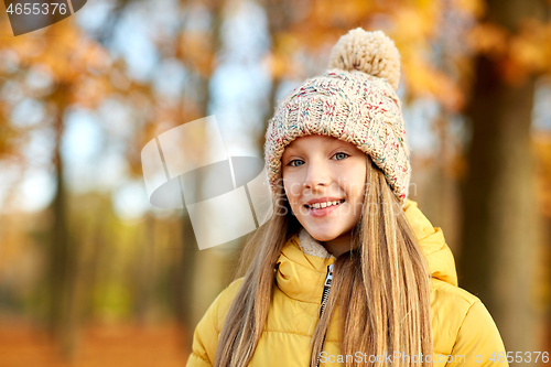 Image of portrait of happy girl at autumn park