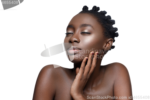 Image of Beautiful black girl touching face