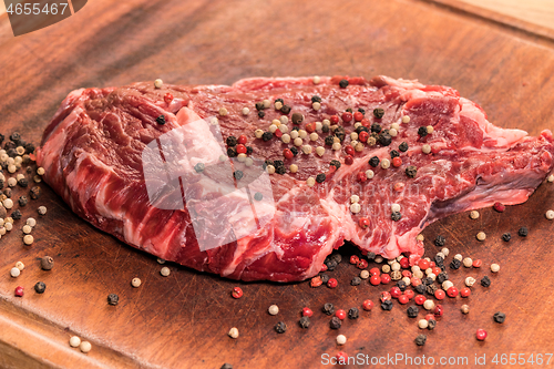 Image of steak of beef on a wooden board