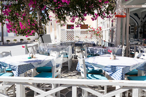 Image of restaurant terrace in front of the beach in kamari on the island