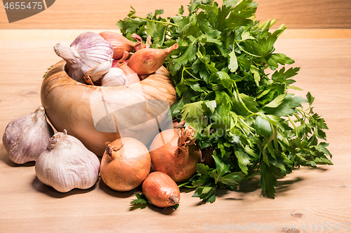 Image of garlic onion shallot parsley with pestle and olive wood mortar