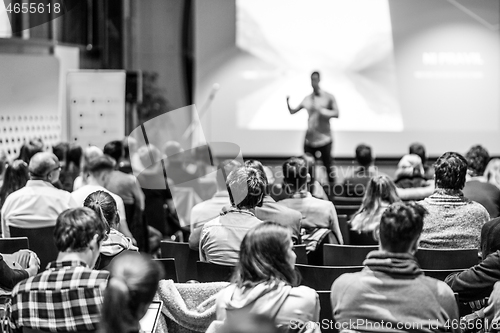 Image of Business speaker giving a talk at business conference event.