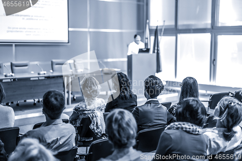 Image of Woman giving presentation in lecture hall at university.