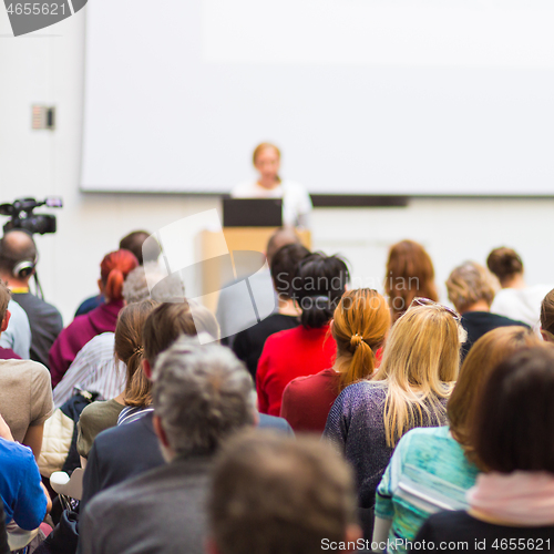 Image of Woman giving presentation on business conference.