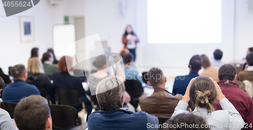 Image of Woman giving presentation on business conference workshop.