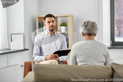 Image of psychologist listening to senior woman patient