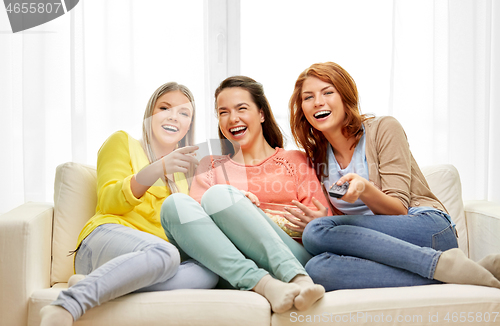 Image of teenage girls or friends watching tv at home