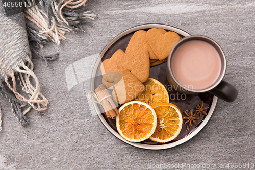 Image of hot chocolate with dried orange, cookies and anise