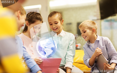 Image of children with tablet pc and earth planet hologram