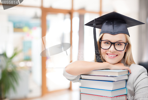 Image of graduate student girl in bachelor hat with books