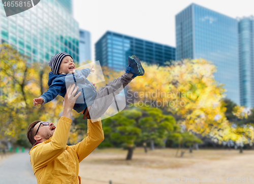 Image of father with son having fun in autumn tokyo city