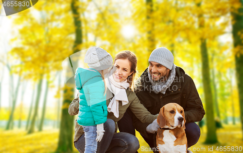 Image of happy family with beagle dog in autumn park