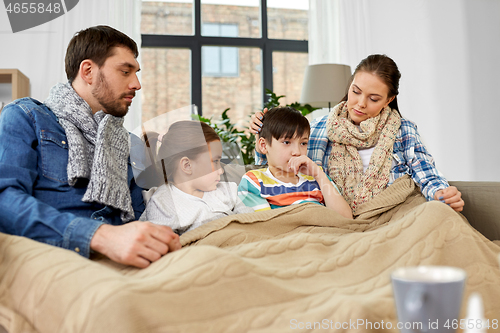 Image of ill family with children having flu at home