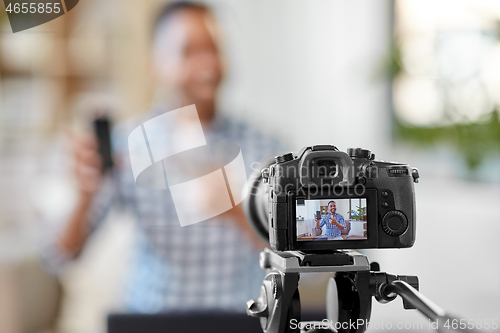 Image of camera recording video blog of smartphone