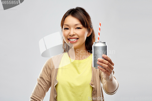 Image of happy asian woman with can drink