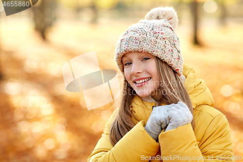 Image of portrait of happy girl at autumn park