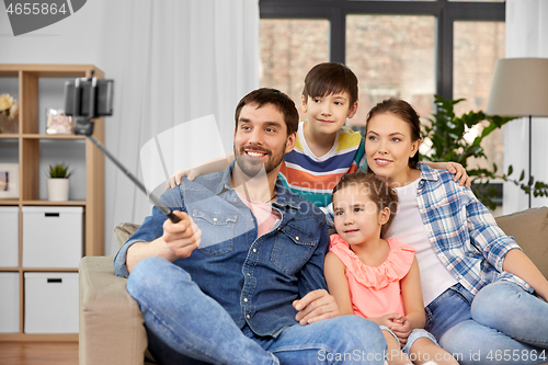 Image of happy family taking selfie at home