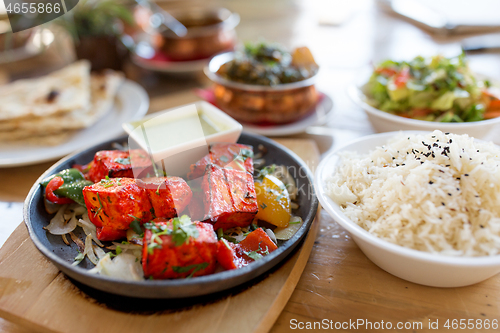 Image of close up of paneer tikka dish with sauce on table
