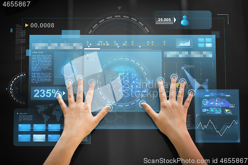 Image of hand using black interactive panel with charts