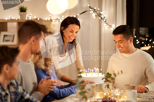 Image of happy family having birthday party at home