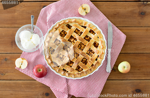 Image of apple pie with ice cream on wooden table