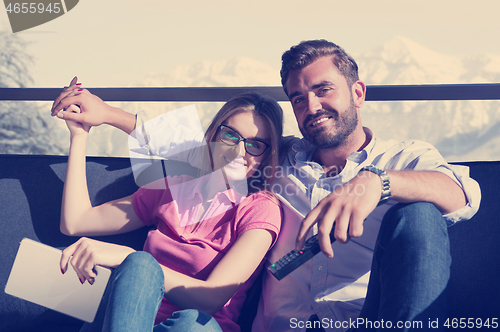 Image of Young couple watching television