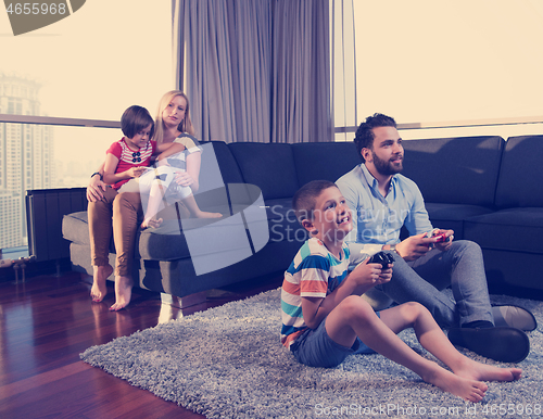 Image of Happy family playing a video game