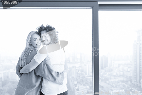 Image of young couple enjoying morning coffee by the window