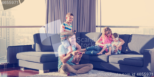 Image of Happy family playing a video game