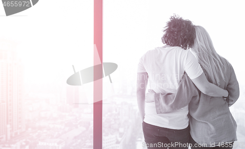 Image of young couple enjoying morning coffee by the window