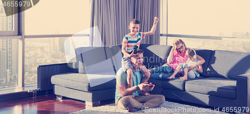 Image of Happy family playing a video game