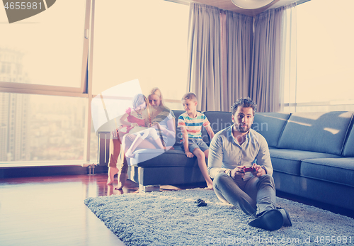 Image of Happy family playing a video game