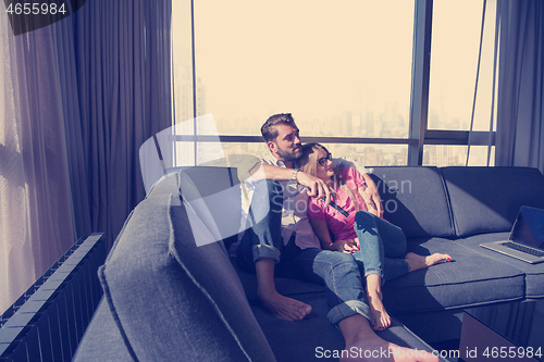 Image of Young couple watching television