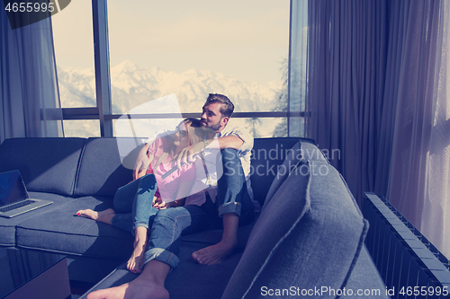 Image of Young couple watching television