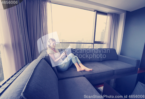Image of young girl enjoying music through headphones