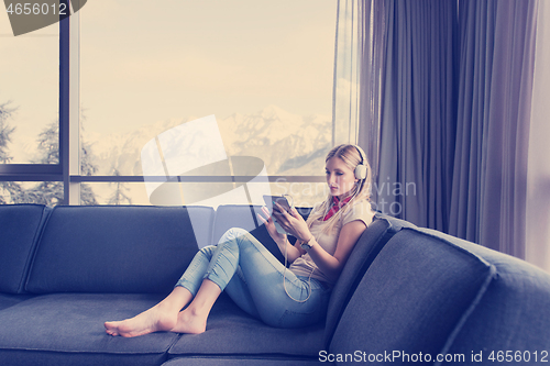 Image of young girl enjoying music through headphones