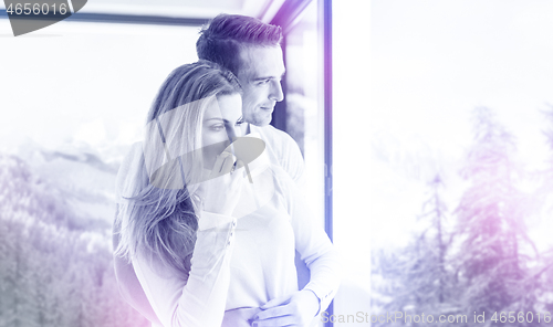 Image of young couple enjoying morning coffee by the window