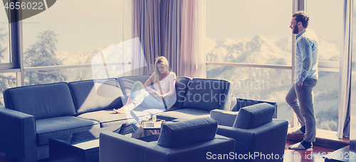 Image of couple relaxing at  home using tablet computer