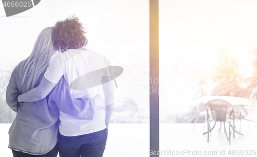 Image of young couple enjoying morning coffee by the window