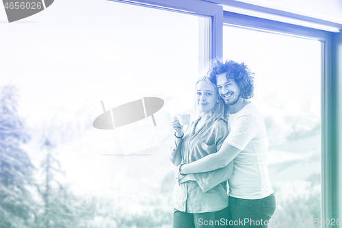 Image of young couple enjoying morning coffee by the window