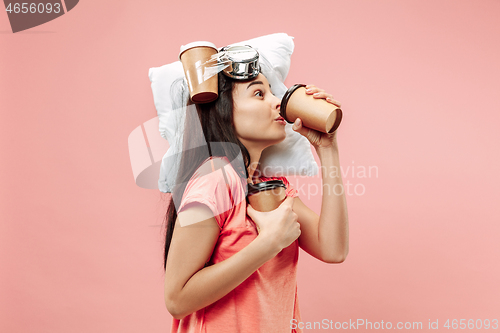 Image of Tired woman at home having too much work. Bored businesslady with pillow and coffee