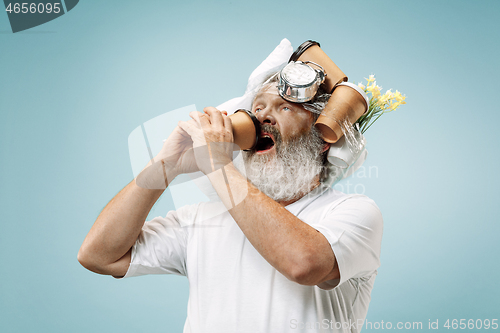 Image of Tired man sleeping at home having too much work. Bored businessman with pillow and hourglass