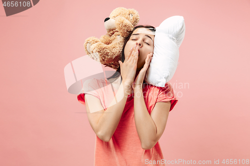 Image of Tired woman sleeping at home having too much work. Bored businesslady with pillow and toy bear