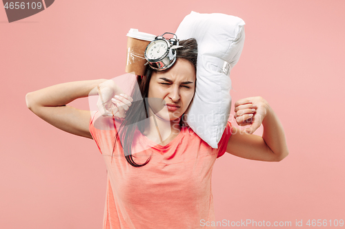 Image of Tired woman at home having too much work. Bored businesslady with pillow and coffee