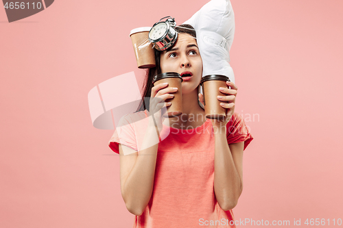 Image of Tired woman at home having too much work. Bored businesslady with pillow and coffee