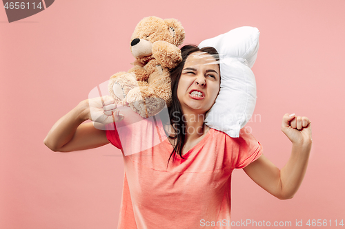 Image of Tired woman sleeping at home having too much work. Bored businesslady with pillow and toy bear