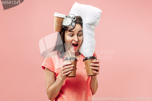 Image of Tired woman at home having too much work. Bored businesslady with pillow and coffee