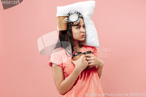 Image of Tired woman at home having too much work. Bored businesslady with pillow and coffee