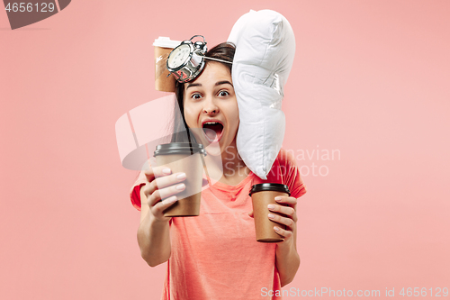 Image of Tired woman at home having too much work. Bored businesslady with pillow and coffee