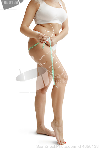 Image of Female body with the drawing arrows. Fat lose, liposuction and cellulite removal concept
